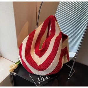 Detail view of the red and white V-pattern crochet knit tote bag for casual beach outings