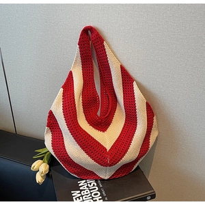 Macro detail of red and white chevron crochet knit pattern on oversized summer tote bag