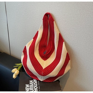 Detailed knit texture of a red and white chevron hollow-out large capacity tote bag
