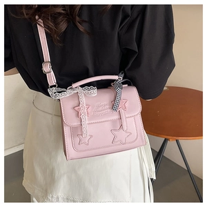 Pink PU leather crossbody bag featuring star applique and delicate white lace ribbon detail