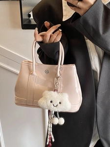 Pink patent leather handbag with plush cloud charm and striped tie detail