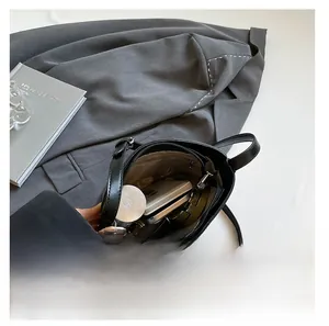 Interior view of black leather bucket bag showing large capacity for essentials