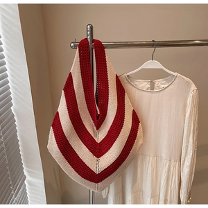 Detailed close-up of the red and white striped knit texture on a hollow-out tote bag