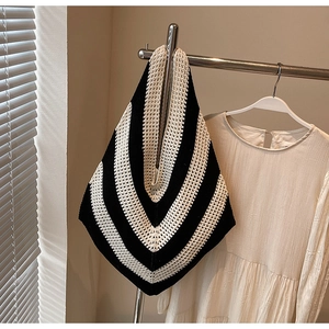 Close-up of black and white V-stripe knitted pattern on a large beach shoulder bag