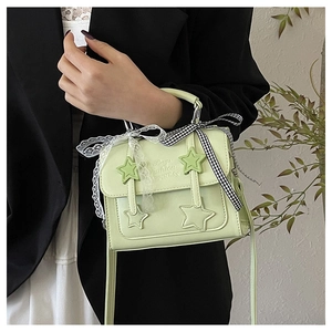 Detail of light green star crossbody bag with bow ribbons and Bags Fashion HAPPINESS text