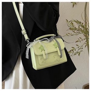 Detail of lime green star handbag featuring delicate lace and plaid ribbon accents