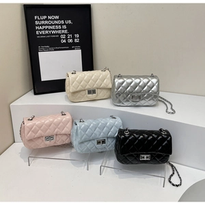 Detailed display of five colorful quilted chain handbags with metallic twist locks
