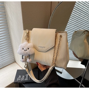 Detail of cream chain shoulder bag with FASHION & BAGS text and cloud charm