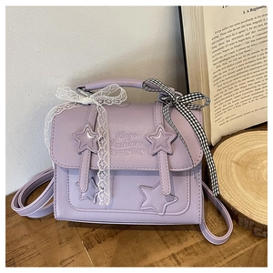 Detail of purple star embossed messenger bag with decorative lace and plaid bows