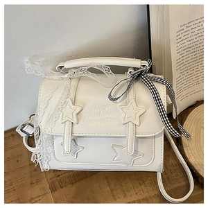 Detailed view of white star pattern satchel with lace trim and checkered bow accent