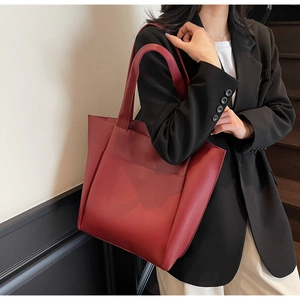 Deep burgundy tote bag featuring a practical front pocket and dual shoulder straps