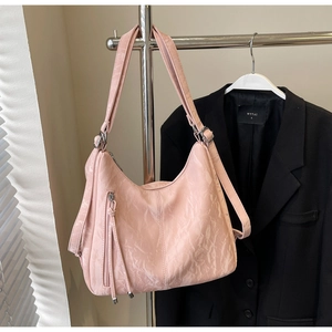 Detailed close-up of pink marble-textured tote bag showing zipper detail and shoulder strap