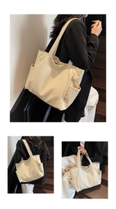 Detail of soft cream white tote bag with lychee texture and side pocket for commuting