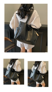 Close-up of black tote bag textured leather and side pocket with elegant light ornament