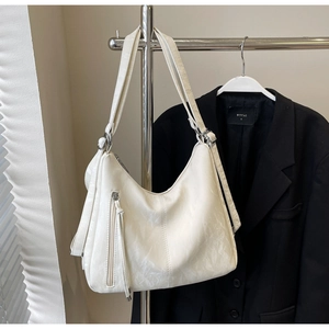 Detail view of cream white PU leather tote bag showing soft texture and vertical zipper