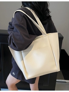 Minimalist cream white leather tote bag for women shown as a stylish shoulder bag