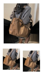 Detail of vintage brown soft leather tote bag showing side pocket and textured material