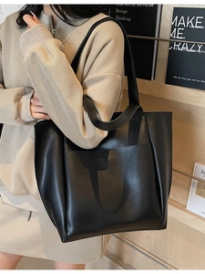 Minimalist black PU leather tote bag for women with large front pocket and wide shoulder straps