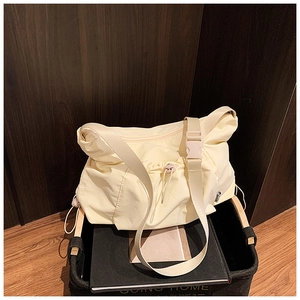 Detail view of adjustable buckle strap and drawstring pleated texture on nylon tote bag
