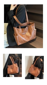 Detail view of brown soft leather tote bag showing side pocket and dual shoulder straps
