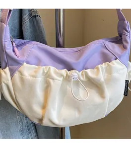 Detail of lavender and cream contrast hobo bag with drawstring pleats and adjustable strap