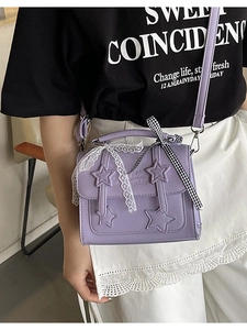 Purple PU messenger bag with star appliques and lace bow detail shown on a model