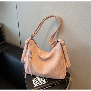 Detail view of pink pleated leather hobo bag texture and silver metal zipper hardware