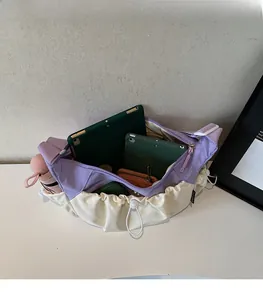 Detailed internal view of large capacity canvas bag holding a tablet and umbrella