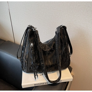 Detail of black Hobo tote bag showing vintage crinkle texture and silver zippers