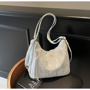 Close-up of the silver-grey metallic pleated texture and vertical zipper on the hobo bag