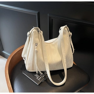 Detail of white hobo shoulder bag with marble texture and side metal zipper pocket