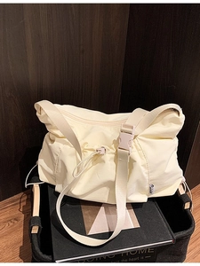 Beige pleated nylon tote bag with drawstring closure for daily commuting and casual style
