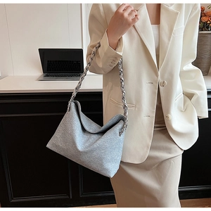 Grey woven texture hobo bag with large silver chain strap shown in a daily setting