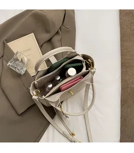 Top view of beige leather shoulder bag showing large interior capacity and compartments