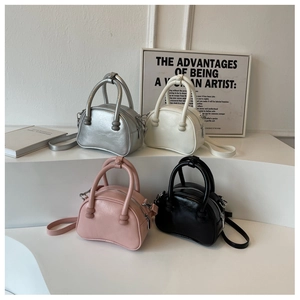 Minimalist leather handbags in silver, white, pink, and black displayed on pedestals