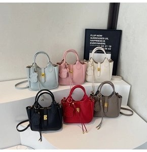 Detail view of colorful faux leather handbags with gold locks and cute dog charms