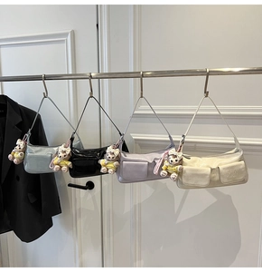 Detail of four colorful baguette bags with plush charms and decorative pockets