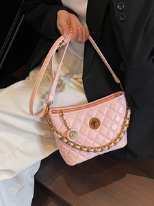 Pink quilted chain crossbody bag with gold turn-lock and elegant metal pendant charm