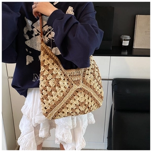 Detail of color-block crochet straw tote featuring hollow flower patterns and thin straps
