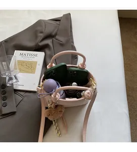 Interior view showing the large capacity of the pink bucket bag for phones and umbrella