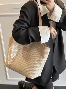 Beige woven straw tote bag with pink leather straps and white lace detail for women
