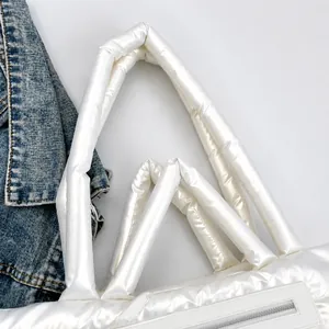 Detail of pearl white padded tote bag with metallic coating and transparent pocket