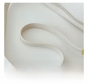 Close-up of white lychee grain leather shoulder bag with adjustable strap and metal buckle
