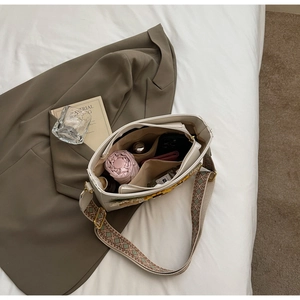 Interior view of floral crossbody bucket bag showing storage for umbrella and phone