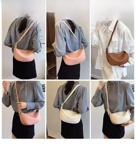 Three minimalist crescent shoulder bags in pink, brown, and cream with adjustable straps