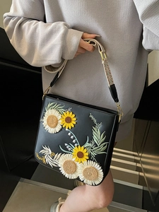 Black leather bucket bag with sunflower embroidery and bohemian wide shoulder strap