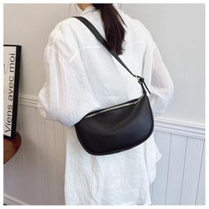 Detail of black hobo bag showing lychee grain texture and gold zipper hardware