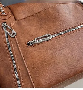 Macro shot of brown pebble grain leather texture with creative silver safety pin zipper pull