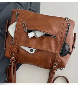 Detail view of the spacious inner compartment and multi-pocket layout of this brown leather tote