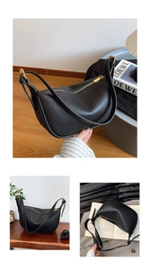 Close-up of the textured lychee grain leather and gold zipper on this black hobo bag